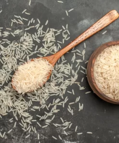 Long grain rice in the spoon and bowl